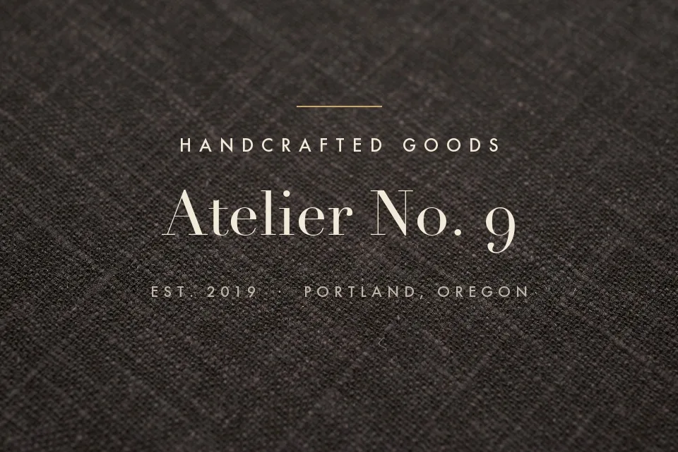 Brand lettering on dark linen fabric, erased with texture intact