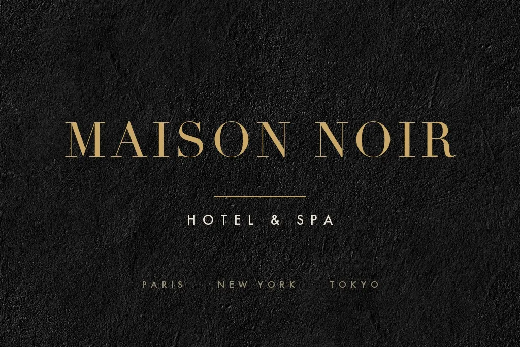 Gold hotel wordmark on matte black stone, removed cleanly